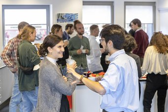 People discussing during the break of a specialist event.