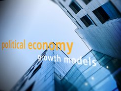 Upward view of modern buildings with reflective glass facades, featuring superimposed text "political economy" in orange and "growth models" in white, suggesting themes of economic growth and development.