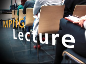 Rows of attendees seated on wooden chairs, some taking notes, at a lecture event hosted by MPIfG.