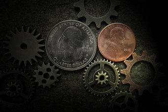 Coins and gears on a dark background.
