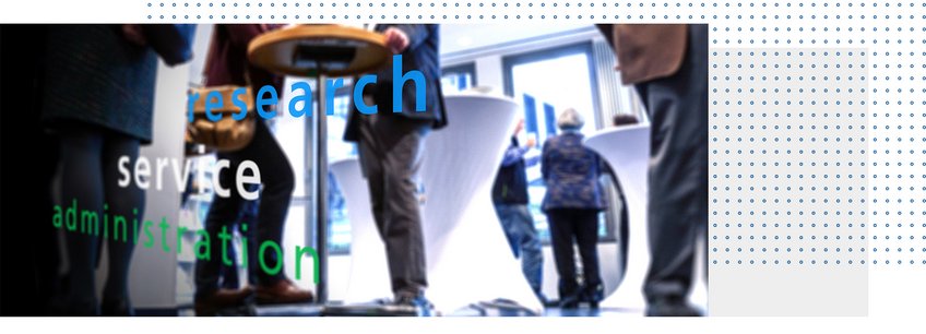 Blurred image of partially visible people standing at a bar table in a large room