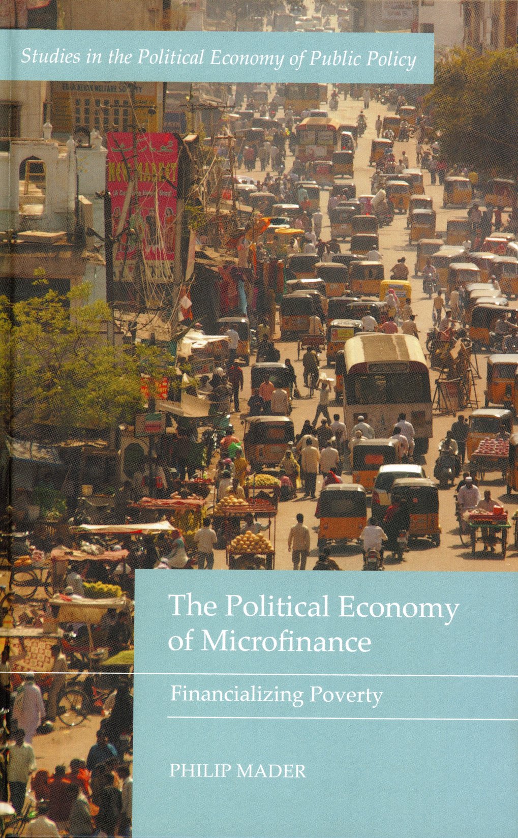 The cover shows a busy city street, cars, and crowds of people. Book title: “The Political Economy of Microfinance: Financializing Poverty” by Philip Mader.