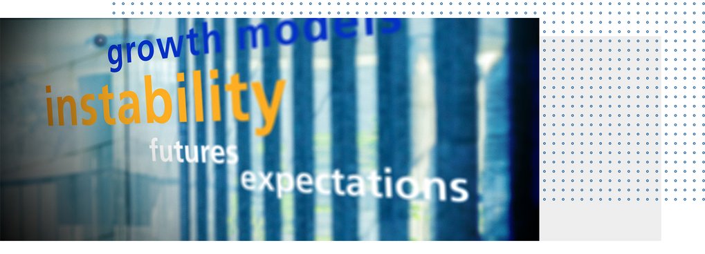 Blurred text on glass wall includes terms like growth, models, instability, futures, expectations, reflecting economic themes.