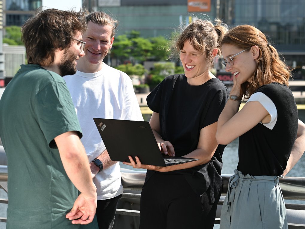 Four individuals talking and smiling