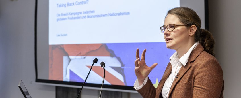 The presentation includes a slide titled "Taking Back Control?" addressing Brexit's balance between economic nationalism and free trade, with a visual of the Union Jack flag.