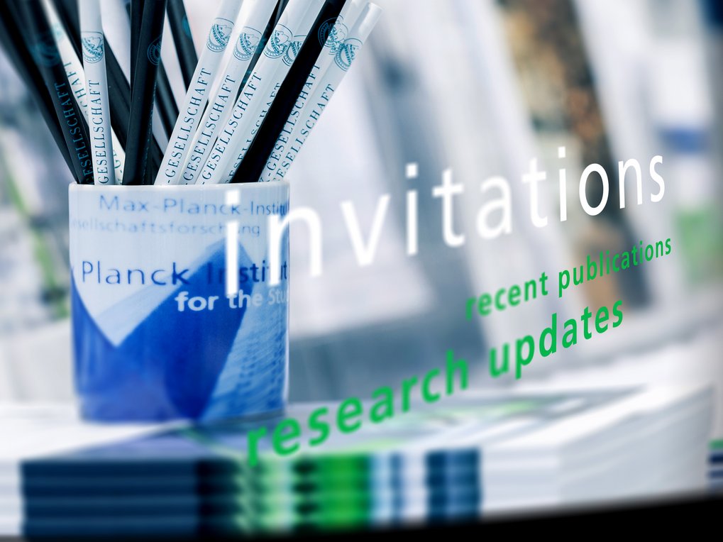 Mug with pencils and a pile of brochures